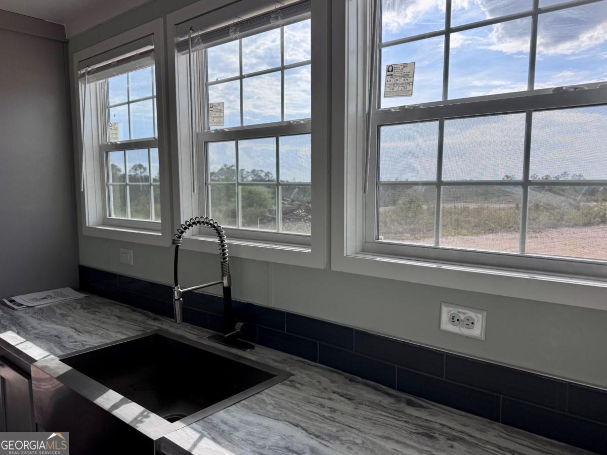 59 Long Leaf Road Hazlehurst, GA 31539 - Photo 2 of 19 a living room with a table chairs and windows