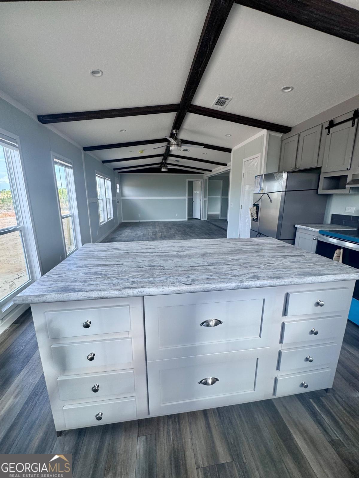59 Long Leaf Road Hazlehurst, GA 31539 - Photo 3 of 19 a view hallway with granite countertop white cabinets and wooden floor