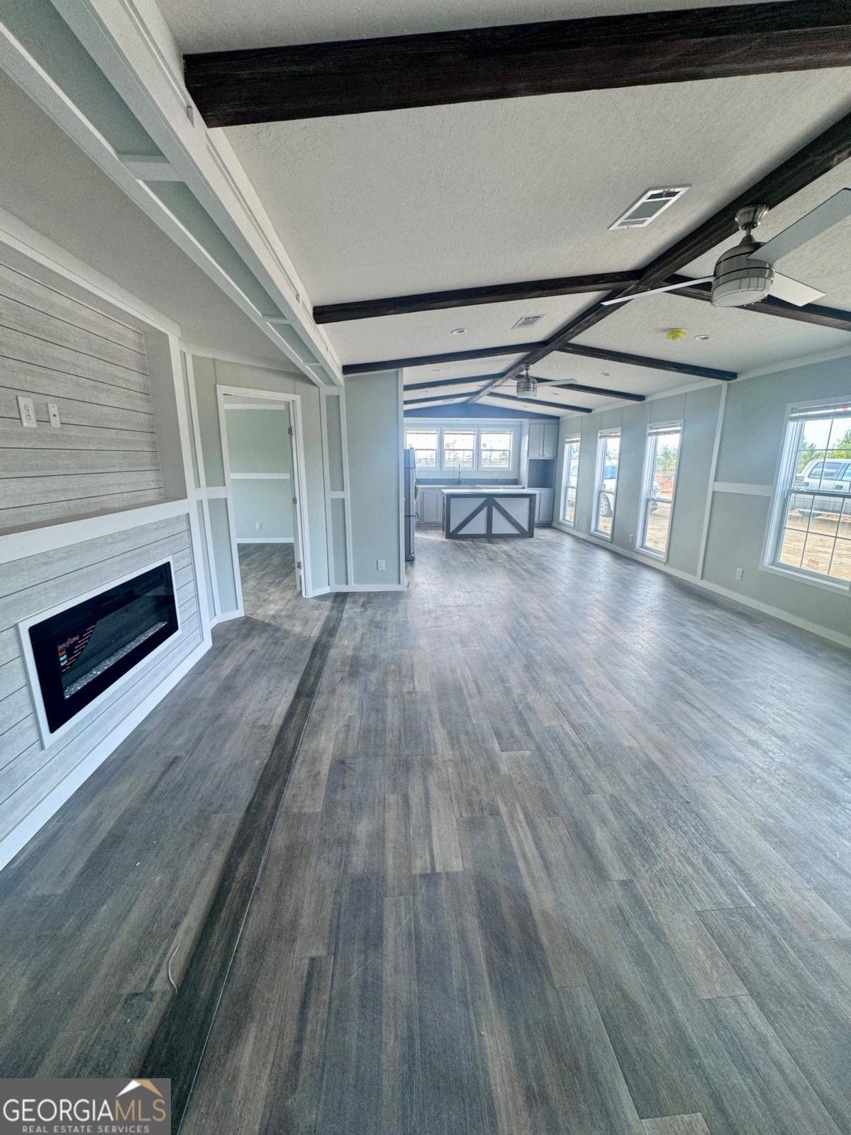 59 Long Leaf Road Hazlehurst, GA 31539 - Photo 7 of 19 a view of empty room with wooden floor and fireplace
