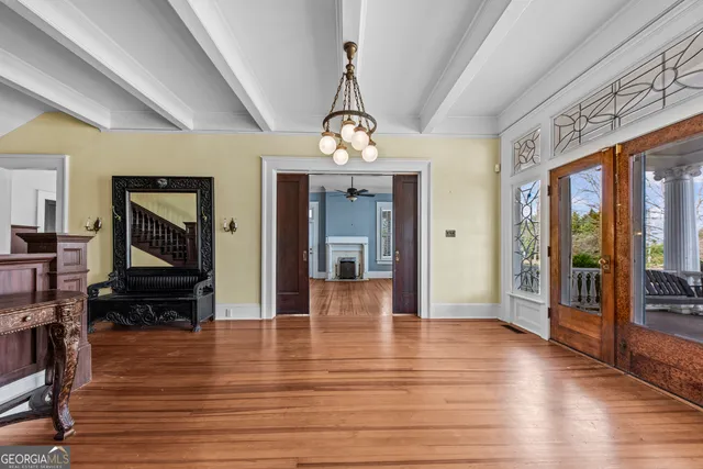 a view of staircase with railing and white walls