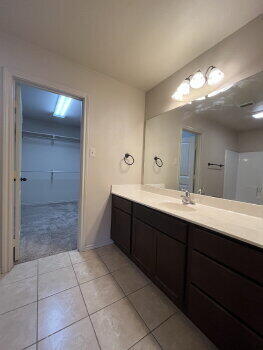 3205 112th Street Lubbock, TX 79423 - Photo 12 of 19 a bathroom with a sink and a mirror