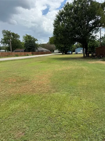a view of yard with swimming pool and trees