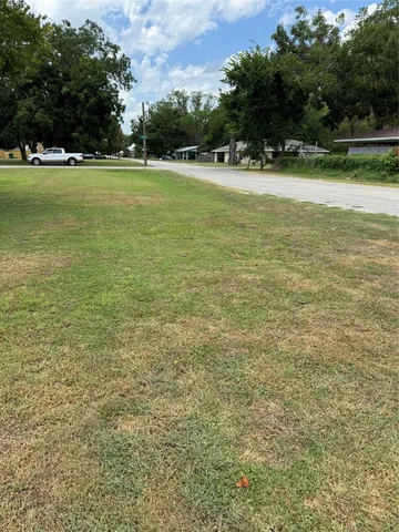 a view of yard with swimming pool and green space