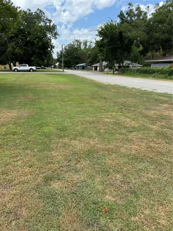 a view of yard with swimming pool and green space