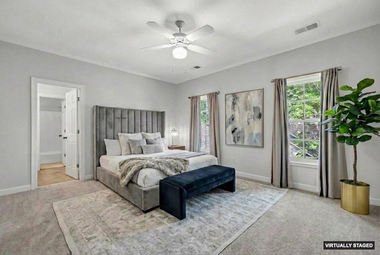 99 Red Acres Place Memphis, TN 38111 - Photo 25 of 39 a spacious bedroom with a large bed a chandelier and a window