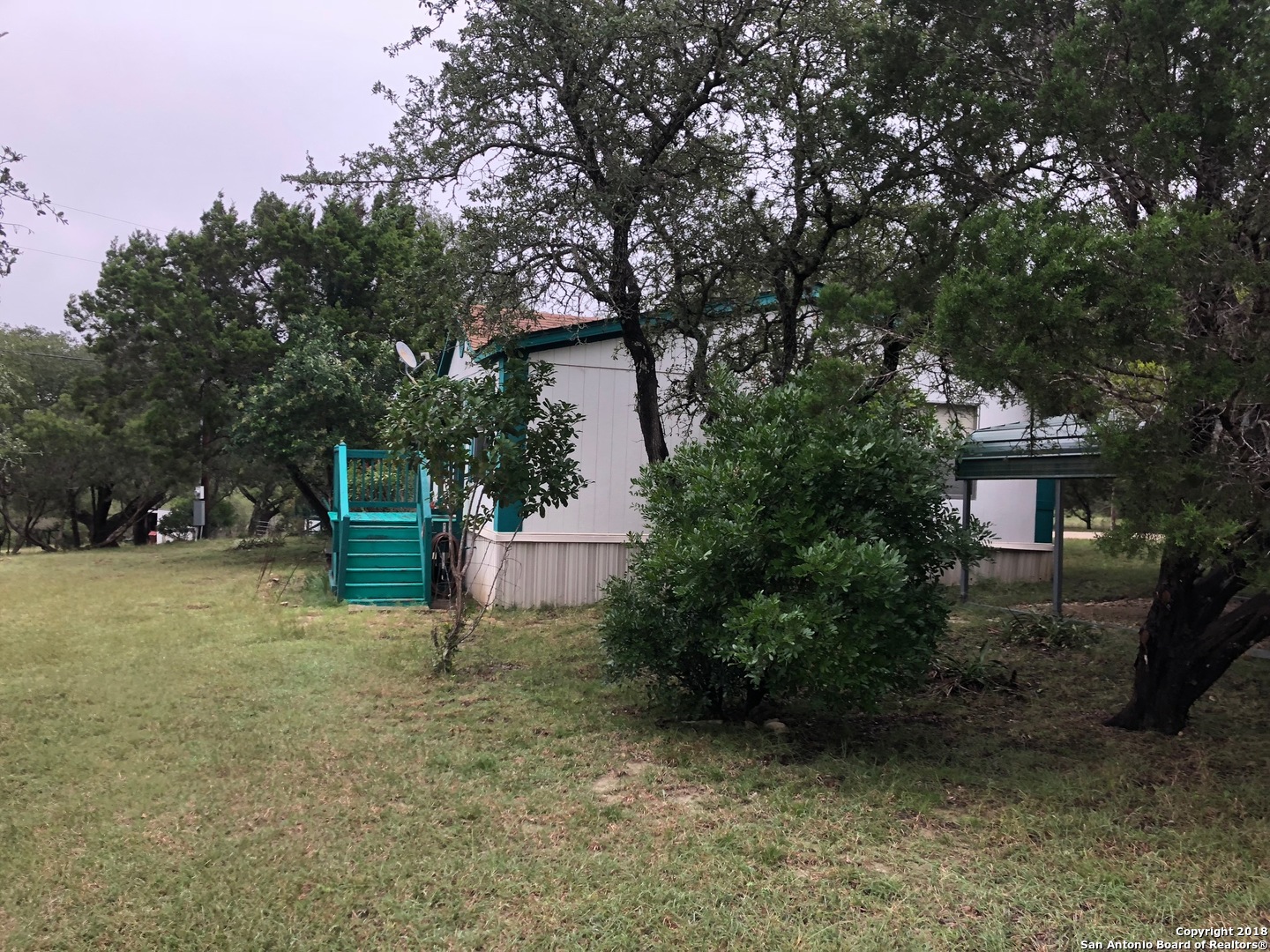 403 Los Indios Road Boerne, TX 78006 - Photo 5 of 21 a view of a tree in front of a house with large trees