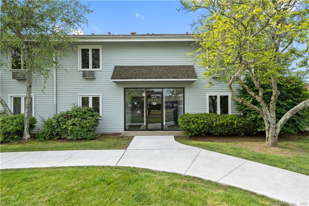 105 Florence Road, Unit 1A Branford, CT 06405 - Photo 1 of 1 a front view of a house with a yard and garage