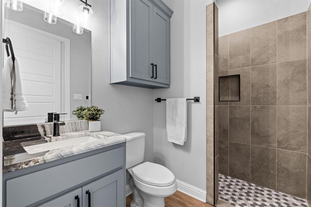Tbd Tbd Anchor Point Quinlan, TX 75474 - Photo 22 of 40 a bathroom with a granite countertop sink a toilet and shower
