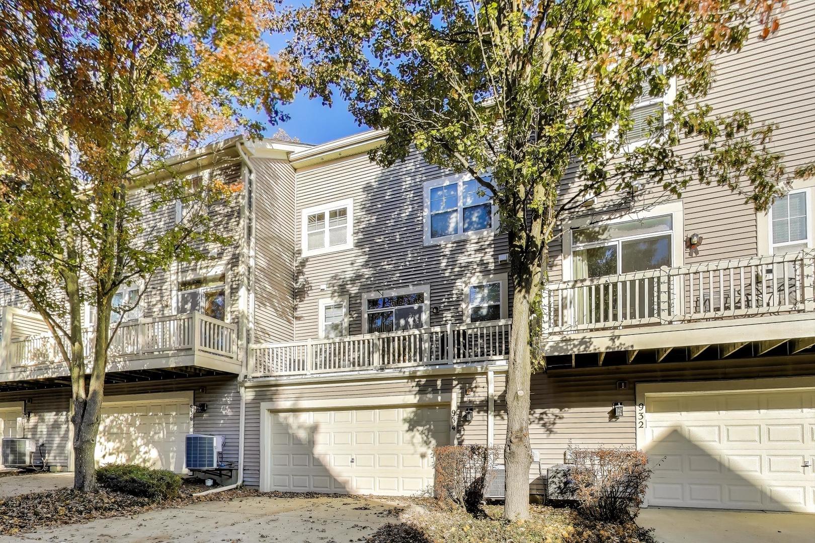 934 Tuscany Drive Streamwood, IL 60107 - Photo 37 of 45 a front view of a building with a tree