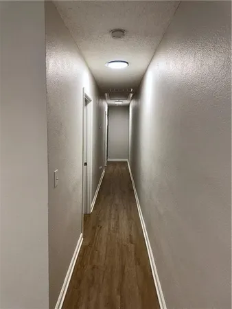 a view of hallway with wooden floor