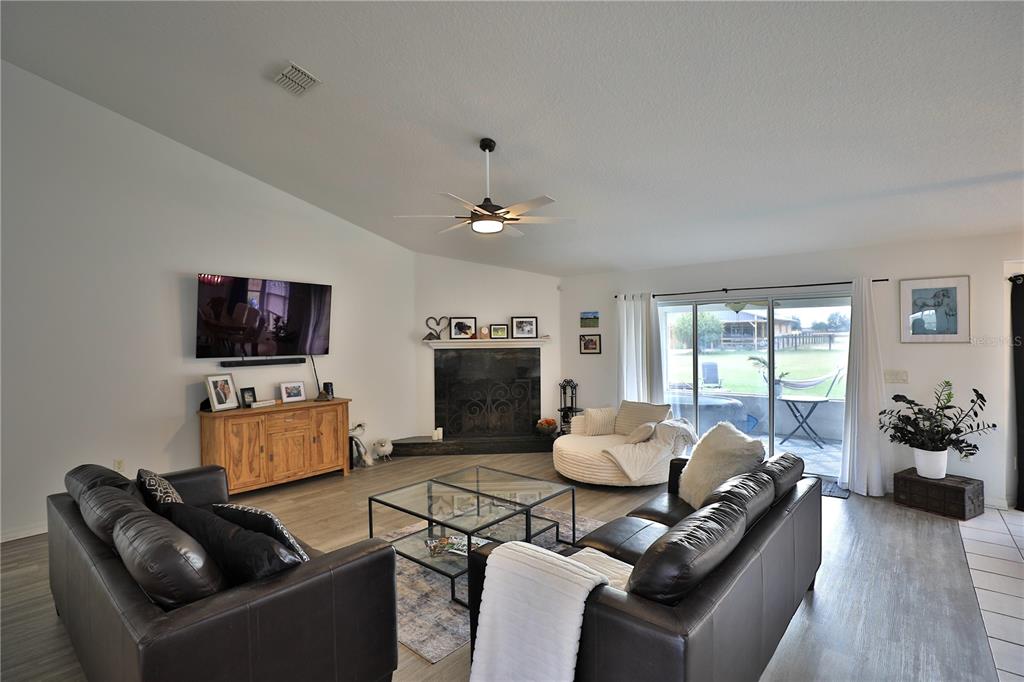 20462 Southwest 36th Street Dunnellon, FL 34431 - Photo 23 of 55 a living room with furniture fireplace and flat screen tv