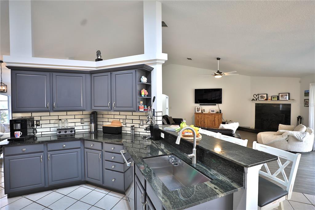 20462 Southwest 36th Street Dunnellon, FL 34431 - Photo 28 of 55 a kitchen with a sink stove and cabinets