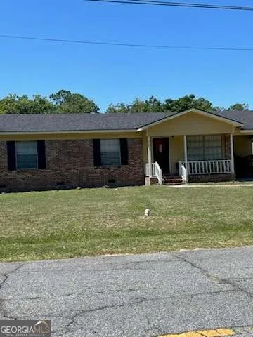 a front view of a house with a yard and a garage