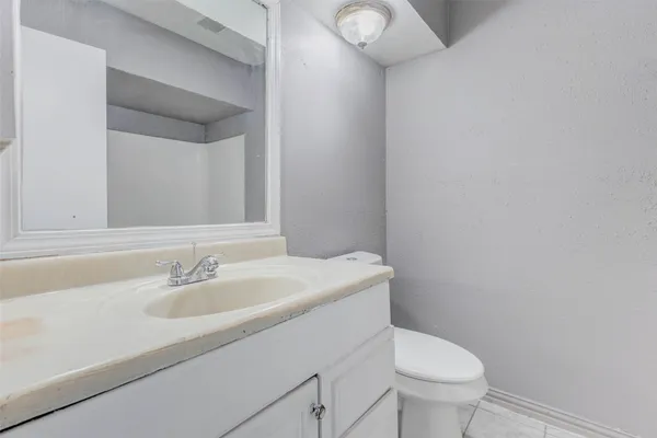 a bathroom with a sink toilet and a mirror
