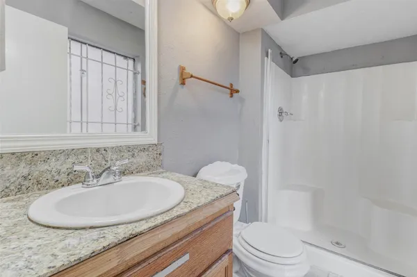 a bathroom with a sink toilet and shower