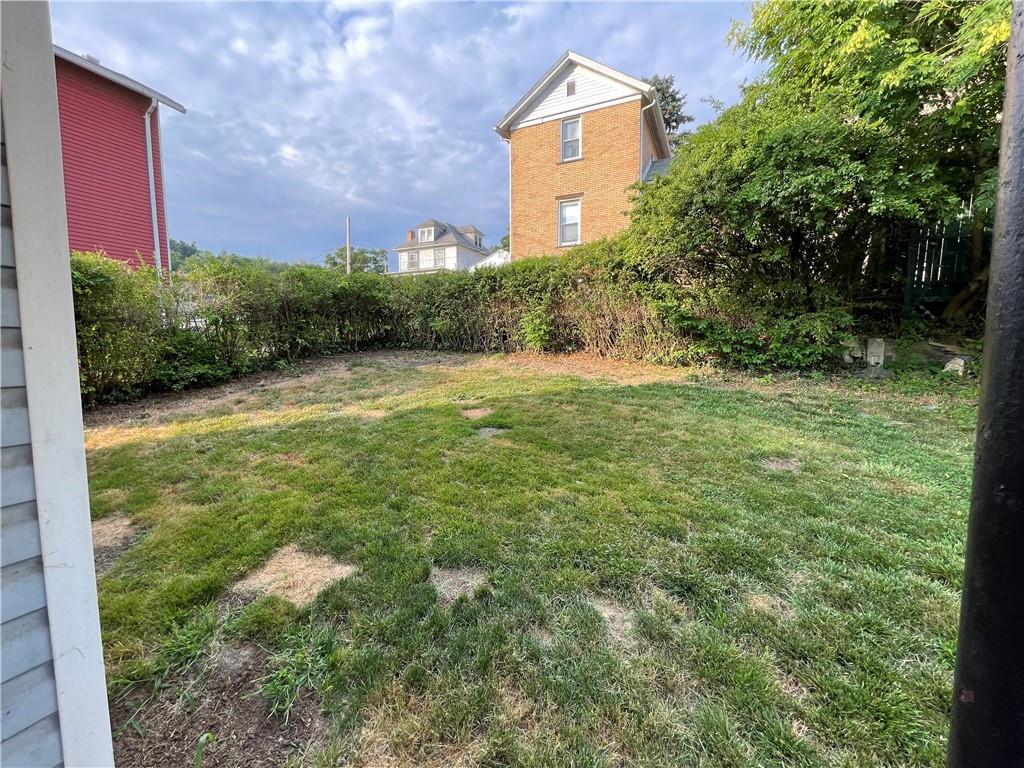 957 4th Avenue Freedom, PA 15042 - Photo 4 of 20 a backyard of a house with lots of green space and plants