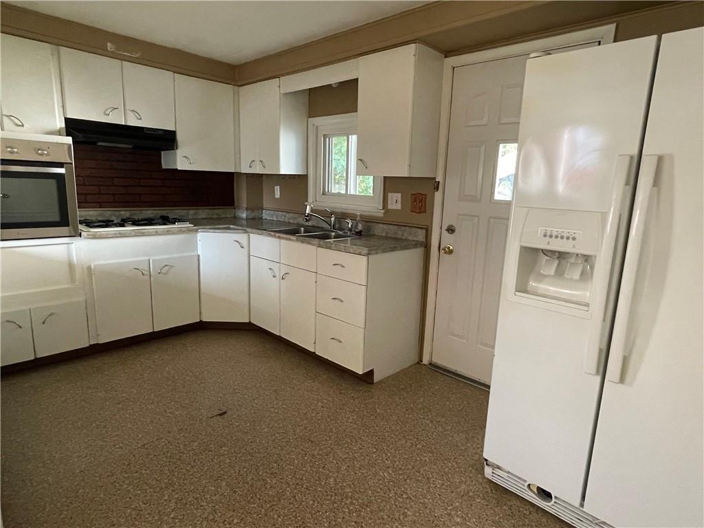 957 4th Avenue Freedom, PA 15042 - Photo 8 of 20 a kitchen with granite countertop white cabinets and refrigerator