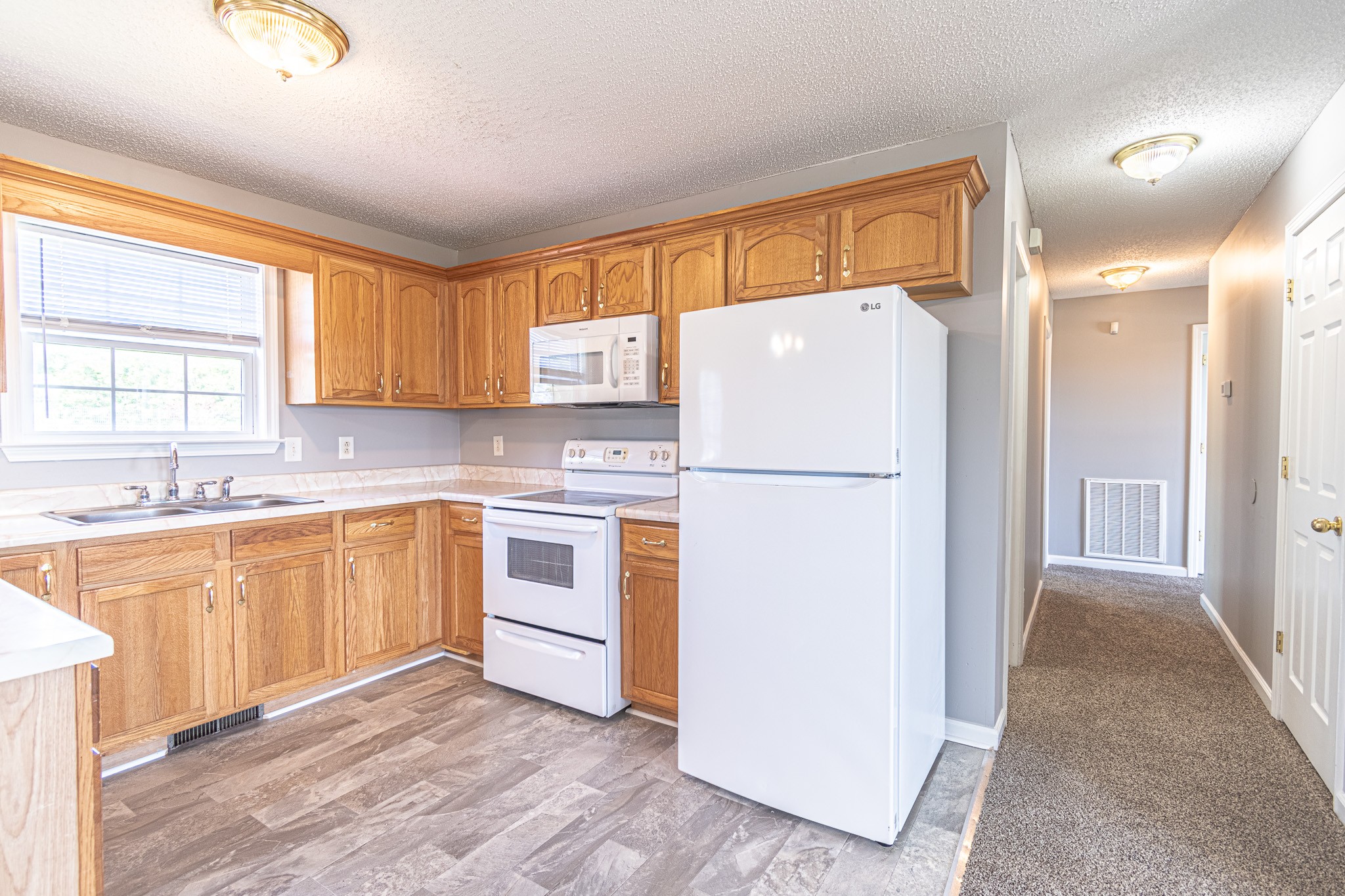 626 Avondale Road Oak Grove, KY 42262 - Photo 3 of 14 a kitchen with cabinets a refrigerator and a sink