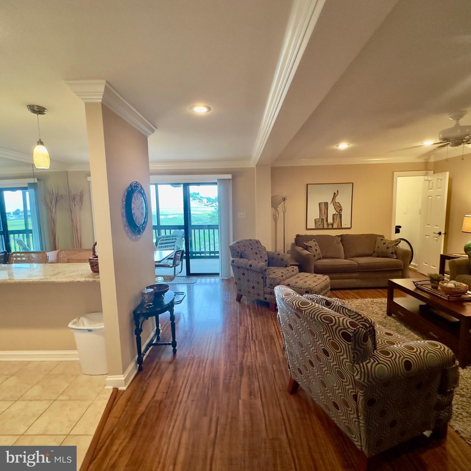 119 Old Landing Road, Unit E203 Ocean City, MD 21842 - Photo 11 of 45 a living room with furniture and a wooden floor