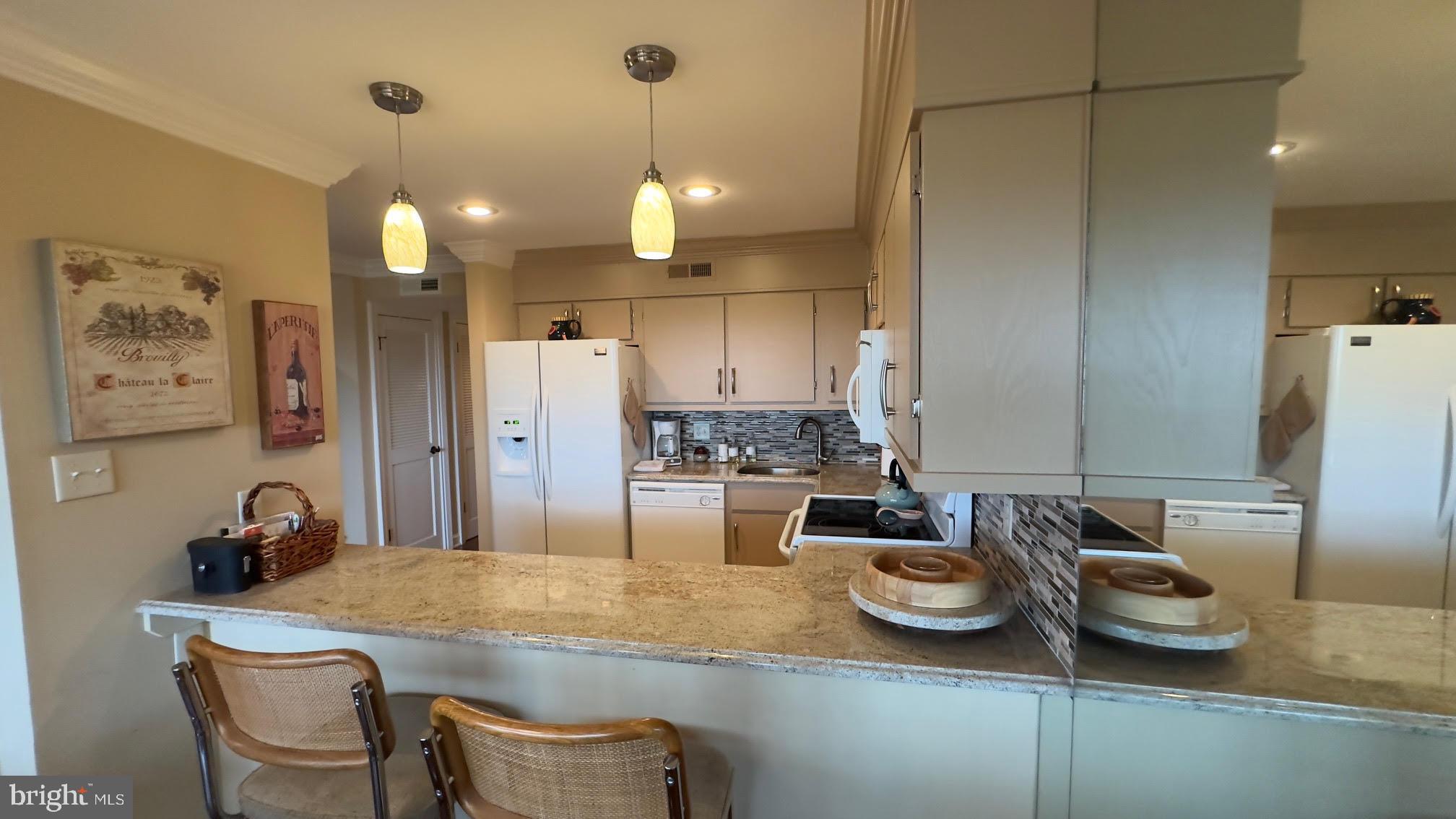 119 Old Landing Road, Unit E203 Ocean City, MD 21842 - Photo 13 of 45 a kitchen with stainless steel appliances granite countertop a sink a stove a refrigerator and island