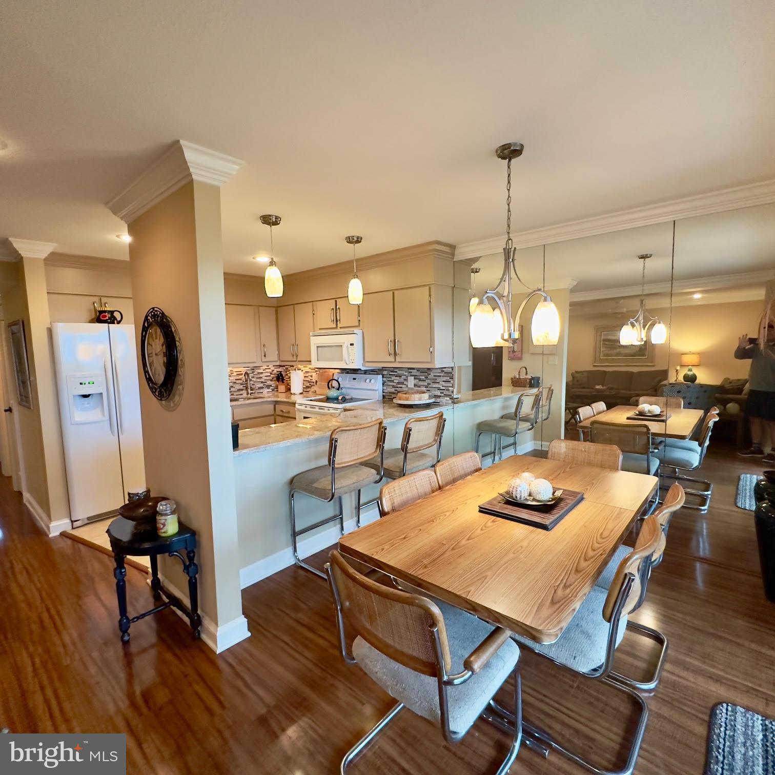 119 Old Landing Road, Unit E203 Ocean City, MD 21842 - Photo 2 of 45 a view of a dining room and livingroom with furniture wooden floor a chandelier