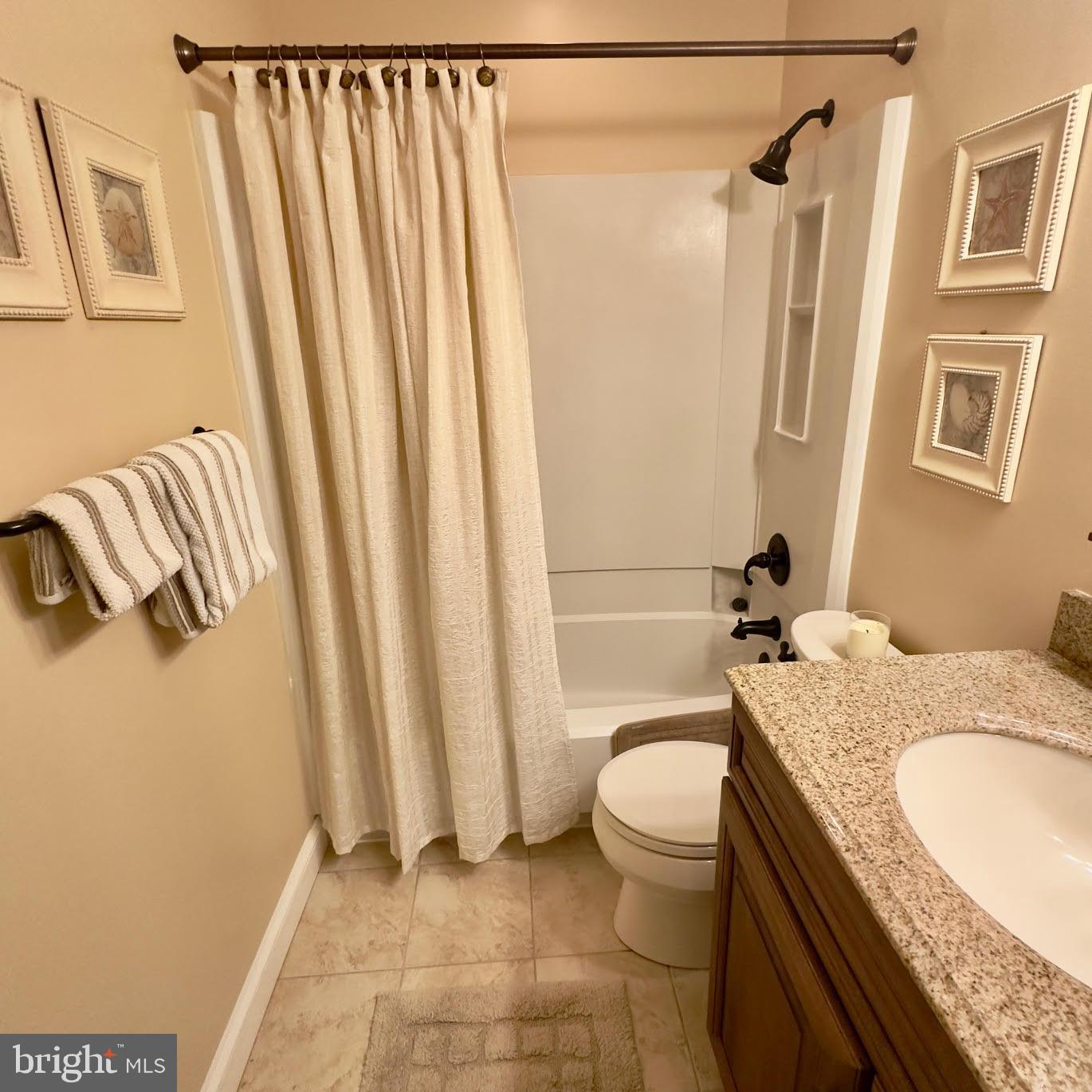 119 Old Landing Road, Unit E203 Ocean City, MD 21842 - Photo 27 of 45 a bathroom with a granite countertop sink toilet and shower