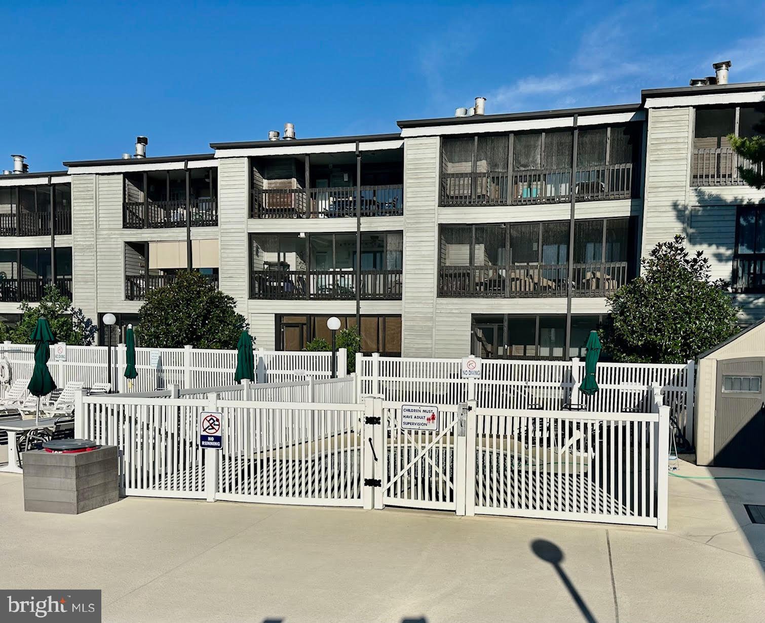 119 Old Landing Road, Unit E203 Ocean City, MD 21842 - Photo 36 of 45 a view of a house with wooden deck and furniture