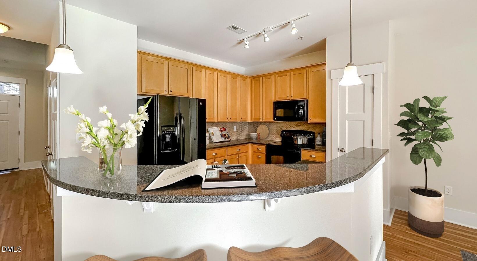 100 Ginkgo Trail, Unit ROSEMARY Chapel Hill, NC 27516 - Photo 21 of 49 a kitchen with a refrigerator and a potted plant