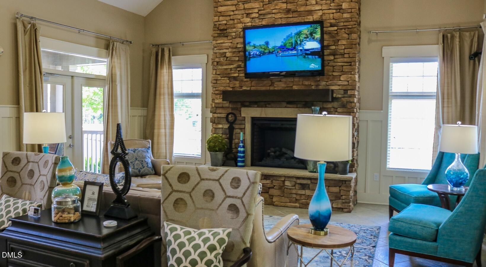 100 Ginkgo Trail, Unit ROSEMARY Chapel Hill, NC 27516 - Photo 5 of 49 a living room with furniture a flat screen tv and a fireplace
