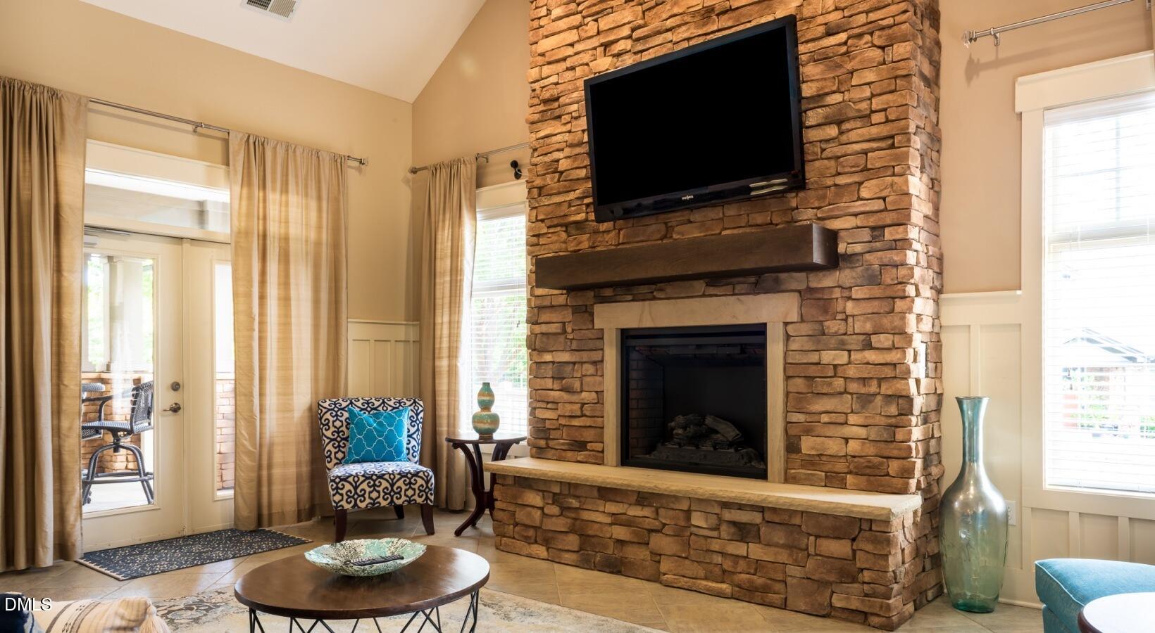 100 Ginkgo Trail, Unit ROSEMARY Chapel Hill, NC 27516 - Photo 9 of 49 a living room with furniture and a flat screen tv