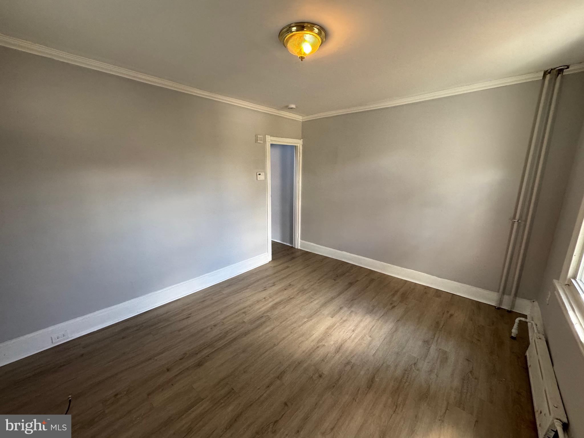 729 East Haverford Road Bryn Mawr, PA 19010 - Photo 7 of 15 wooden floor in an empty room with a window