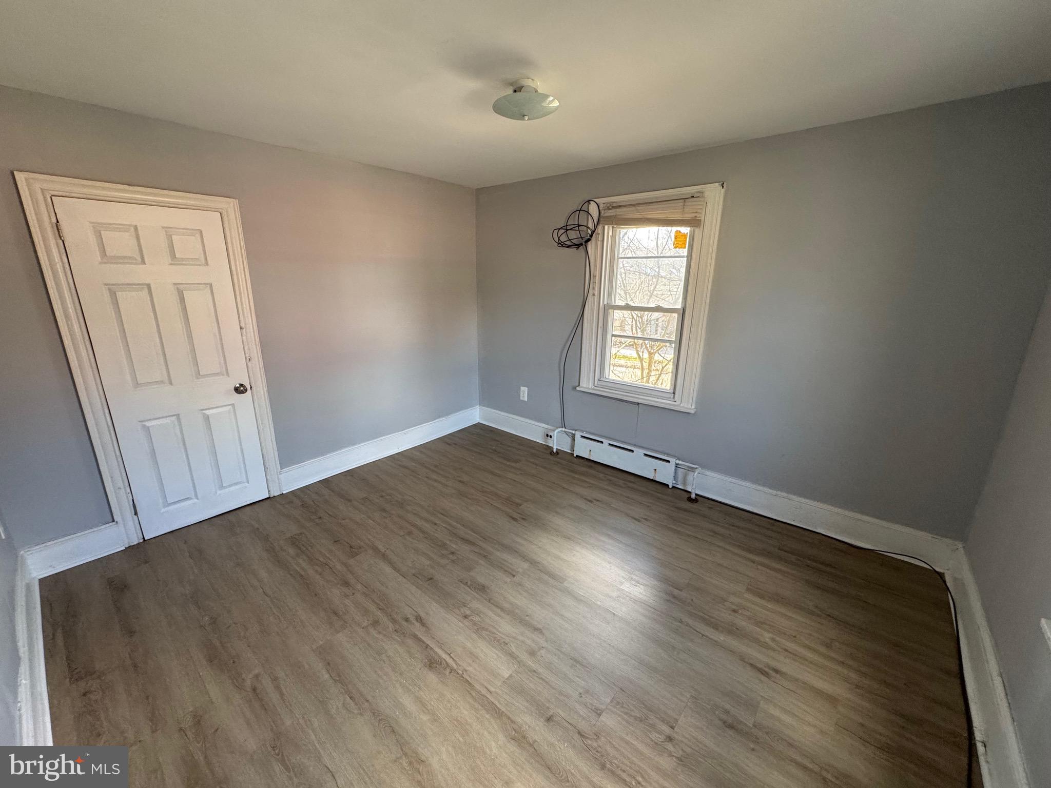 729 East Haverford Road Bryn Mawr, PA 19010 - Photo 8 of 15 an empty room with wooden floor and windows