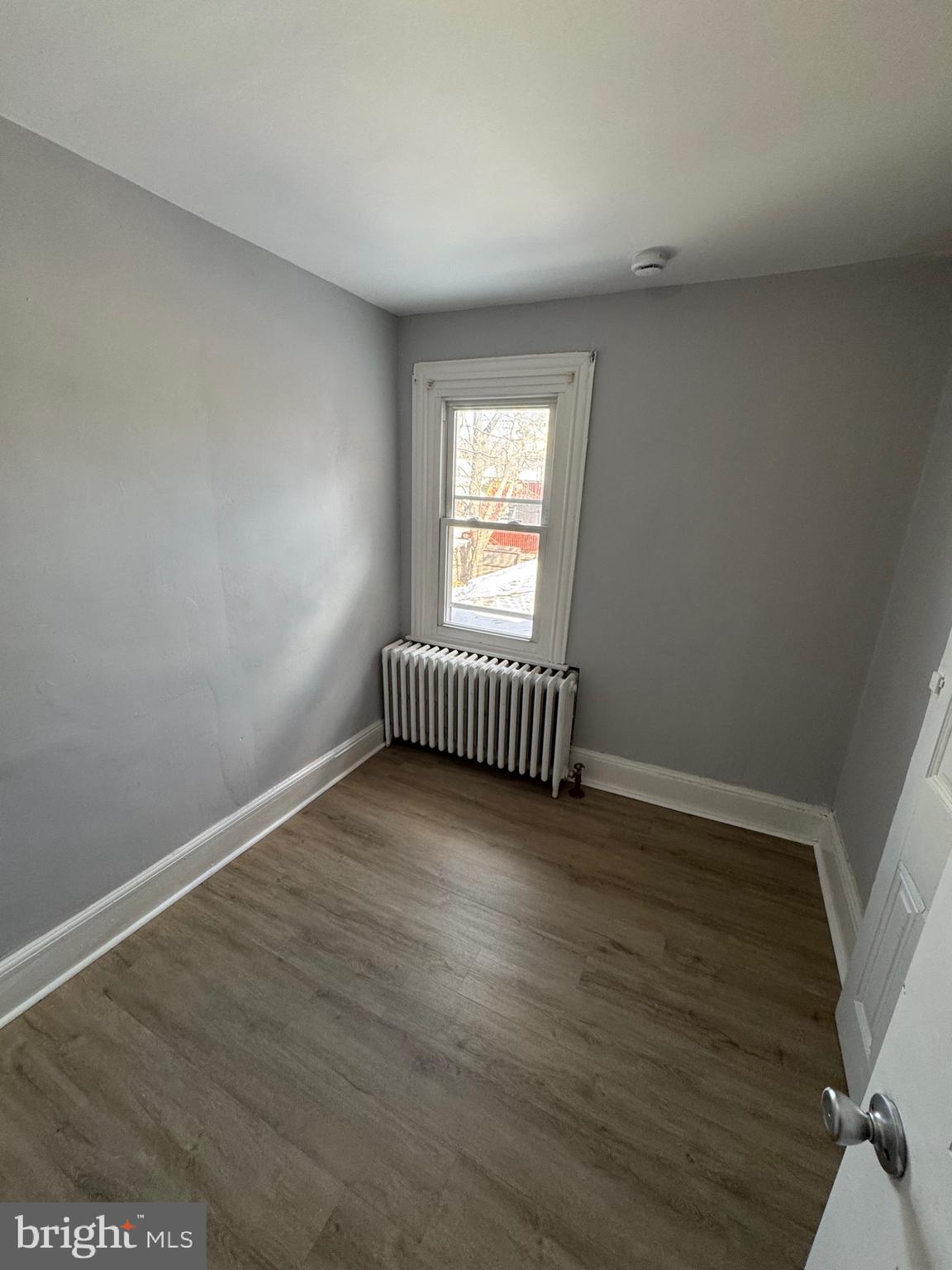 729 East Haverford Road Bryn Mawr, PA 19010 - Photo 10 of 15 an empty room with wooden floor and a window