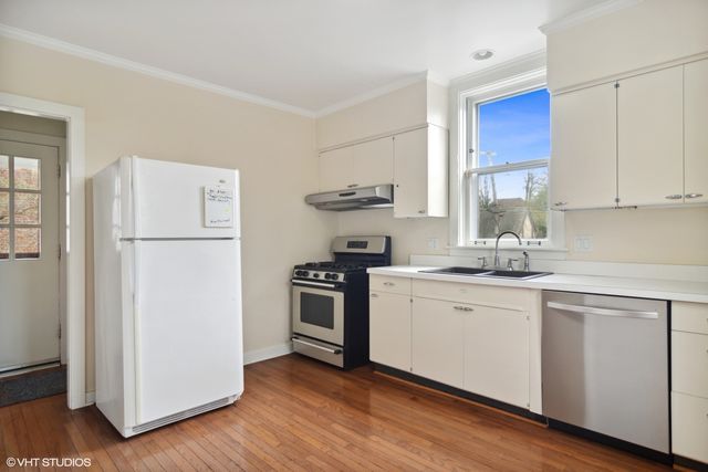 a kitchen with a refrigerator sink and stove