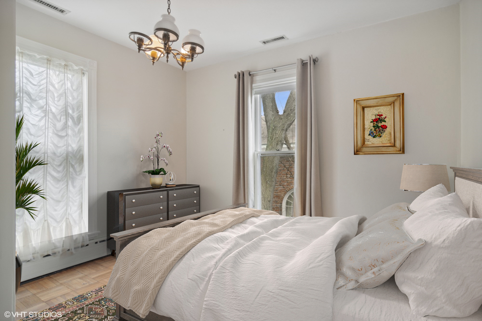 240 Beach Road Glencoe, IL 60022 - Photo 22 of 37 a bedroom with a bed and a chandelier