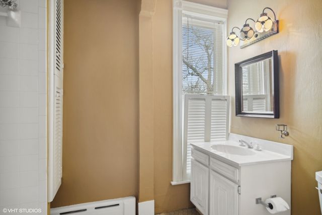 a bathroom with a shower and a toilet sink