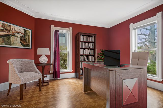 a work room with furniture and a flat screen tv