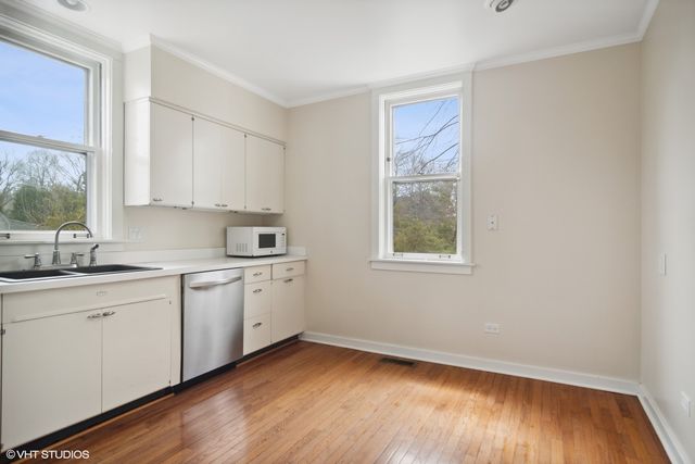 a kitchen with sink and cabinets