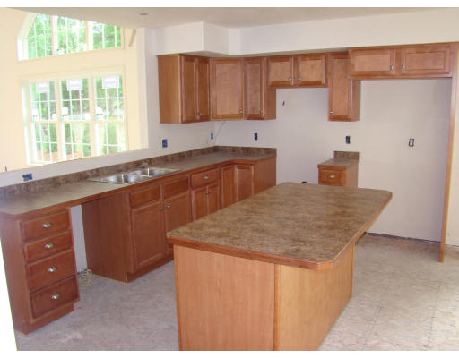 35 Little Turnpike Road Shirley, MA 01464 - Photo 12 of 22 a kitchen with stainless steel appliances granite countertop a sink dishwasher and a stove with wooden cabinets