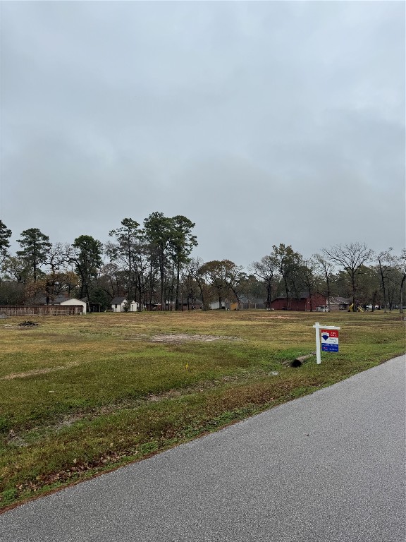 a view of a golf course with a wooden fence