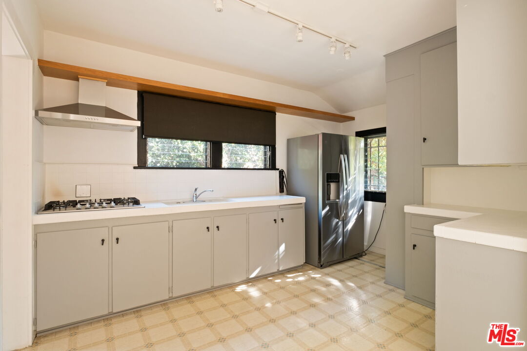 813 North Orange Grove Avenue Los Angeles, CA 90046 - Photo 11 of 42 a spacious bathroom with a sink and a mirror