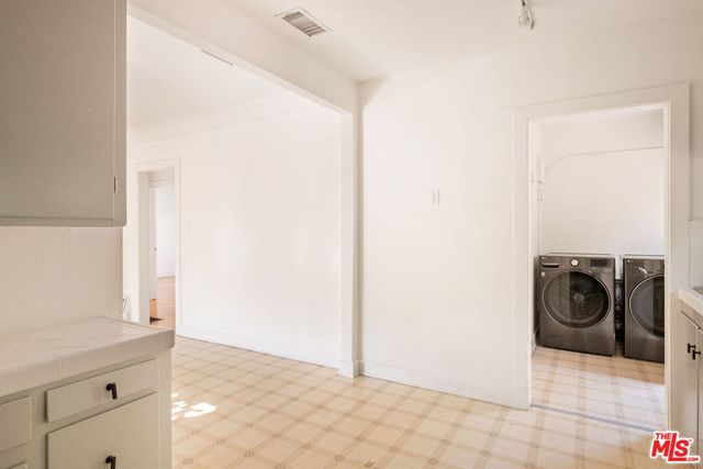 a view of a storage & utility room with a sink