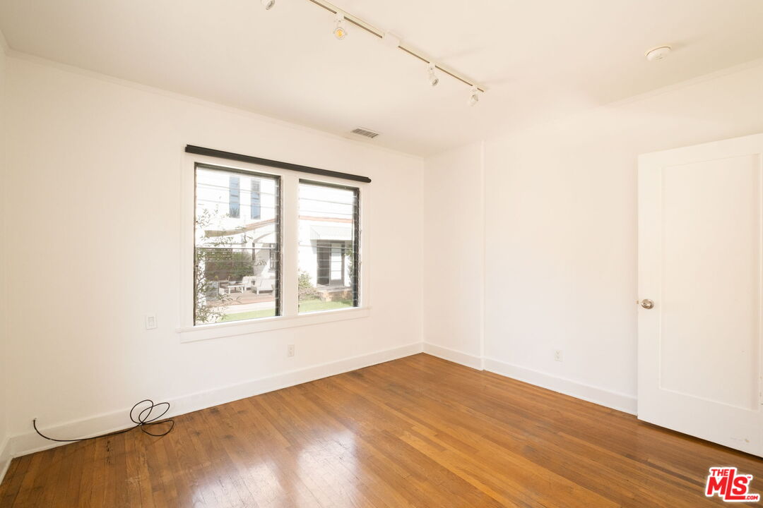 813 North Orange Grove Avenue Los Angeles, CA 90046 - Photo 18 of 42 an empty room with wooden floor and windows