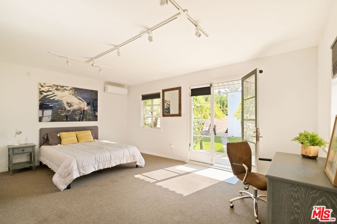 813 North Orange Grove Avenue Los Angeles, CA 90046 - Photo 27 of 42 a bedroom with a bed and a desk