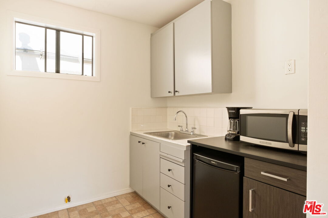 813 North Orange Grove Avenue Los Angeles, CA 90046 - Photo 29 of 42 a kitchen with a sink and cabinets