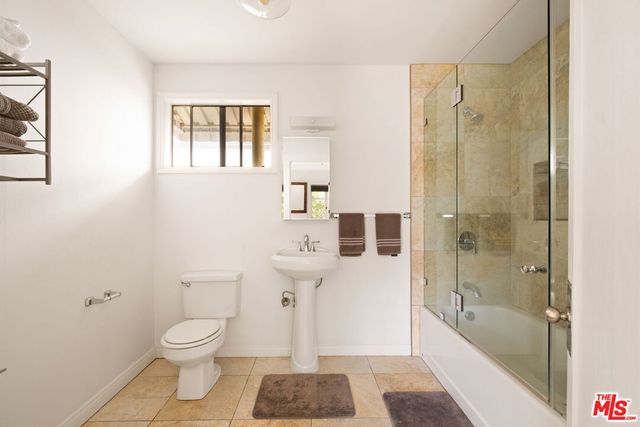 a bathroom with a bathtub a sink and a shower