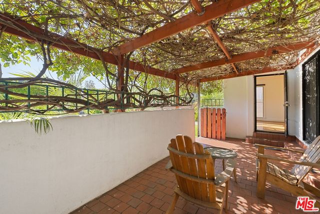 a view of a patio with table and chairs