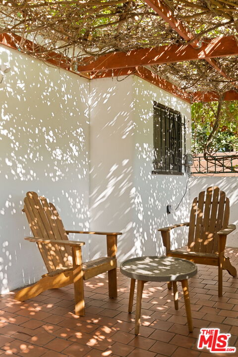813 North Orange Grove Avenue Los Angeles, CA 90046 - Photo 35 of 42 a view of a patio with table and chairs