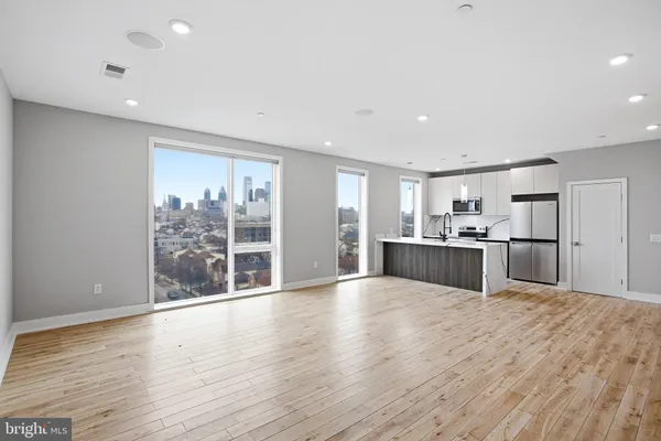 a view of a living room with wooden floor