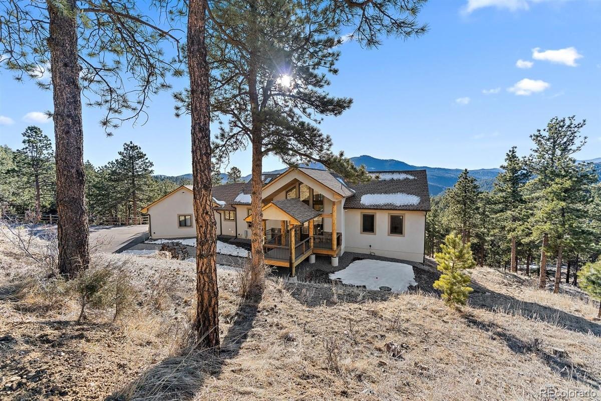 2848 Quartz Ridge Road Evergreen, CO 80439 - Photo 40 of 40 a house that has a tree in front of it